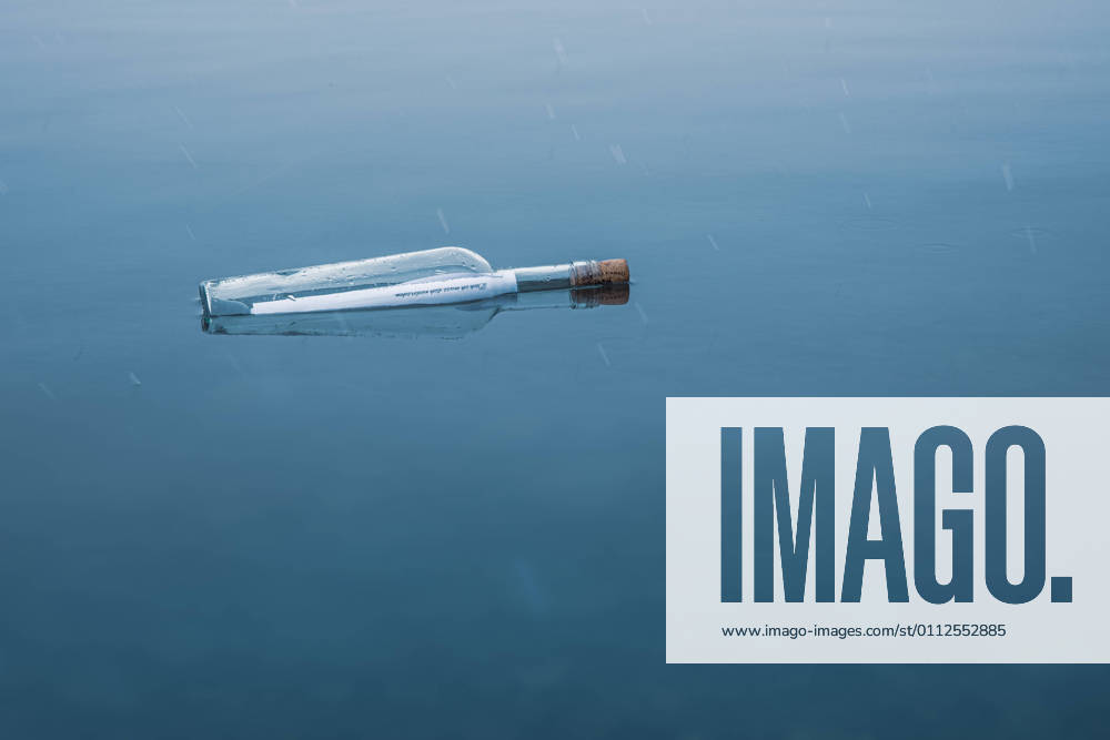 Bottle with message in bottle in winter at lake, snowy message in bottle