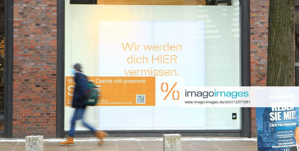 In the window of a retail store closed during the lockdown is a sticker indicating discount promotions Downtown Hamburg