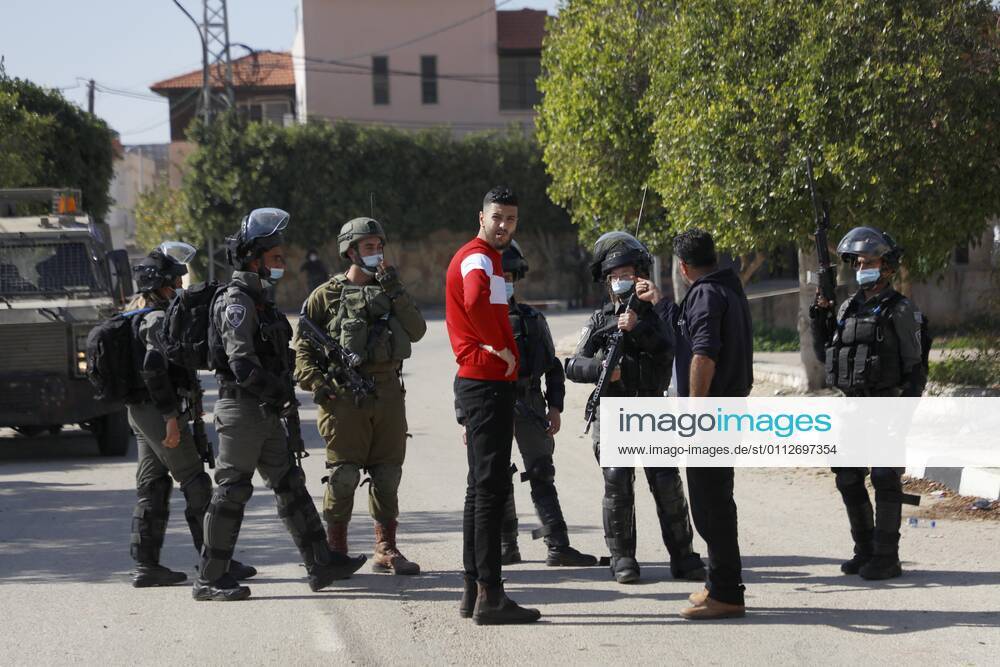 Jenin, West Bank, Palestinian Territory: Israeli security forces stand guard near the house of Palestinian Mohammed Kabaha, who was allegedly accused by the Israeli occupation of killing an Israeli settler in late December 2020, as they prepare to blow it up, in the West Bank village of Tura al-Gharbiya near Jenin, on February 10, 2021. Israeli forces earlier today raided the village of Tura, southwest of Jenin, and declared it a closed military zone, before proceeding to plant explosives and demolish the exterior walls of Kabahas two-story family home, which houses his wife and four children Jenin Palestinian Territory - ZUMAap3_ 20210210_zaf_ap3_053