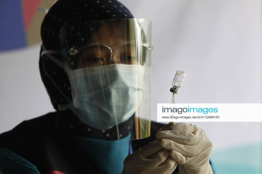 Indonesia s COVID-19 Mass Vaccination A health worker prepares a SinoVac COVID-19 vaccine during a mass vaccination for medical workers and elderly people in Bogor, West Java on February 11, 2021. (Photo by Adrian INA Photo Agency)