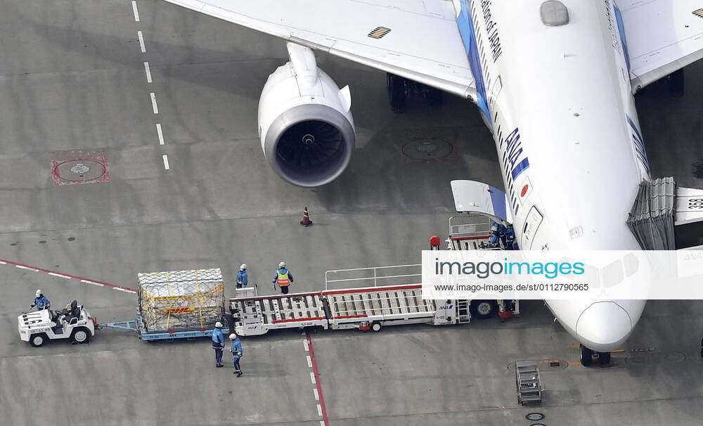 1st batch of Pfizer COVID-19 vaccine arrives in Japan Photo taken from a Kyodo News helicopter on Feb. 12, 2021, shows cargo being unloaded at Narita airport near Tokyo from an airplane that transported from Brussels the first batch to arrive in Japan of the coronavirus vaccine developed by U.S. pharmaceutical giant Pfizer Inc.