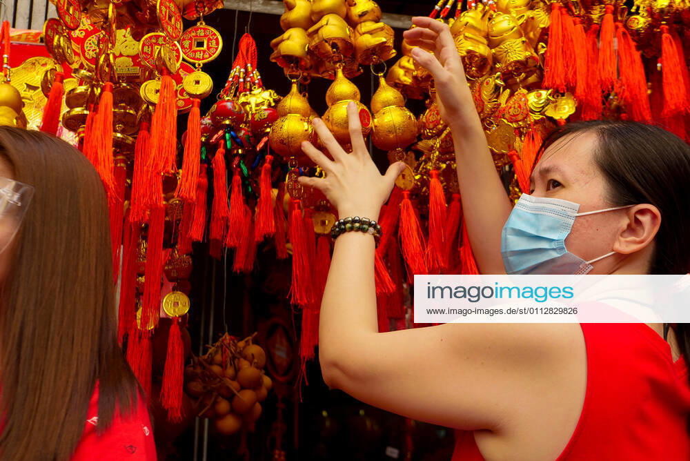 A passerby ignores the vendor selling lucky Chinese lanterns...Manila cancels the dragon dance and lion dance this Chinese New Year due to the pandemic. Manila Philippines - ZUMAb178 20210212_zap_b178_004