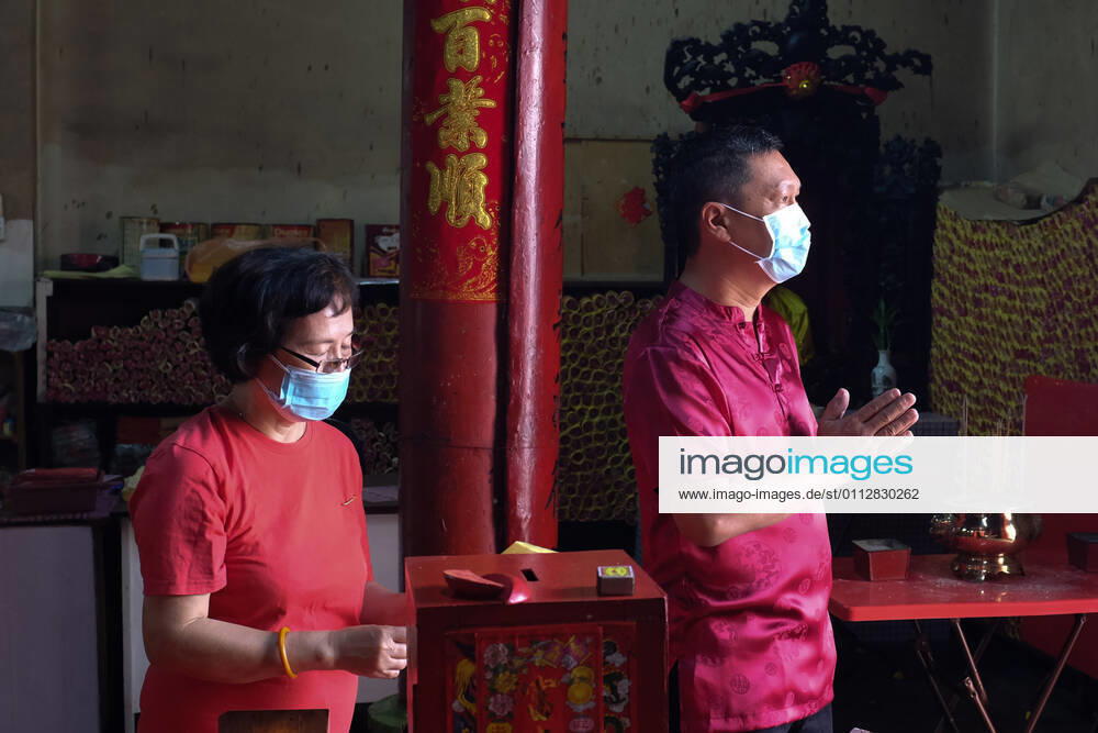 Visitors offering prayers at a temple in Seremban, Negeri Sembilan while wearing face masks during the COVID-19 pandemic. This yearâ€⠢s Lunar New Year festivities are subdued due to the strict measures imposed such as no interstate or inter-district travels as well as no mass gathering to halt the spread of the pandemic...Spring Festival or the Lunar New Year, is the festival that celebrates the beginning of a new year on the traditional lunisolar Chinese calendar. - ZUMAn290 20210212_zip_n290_002