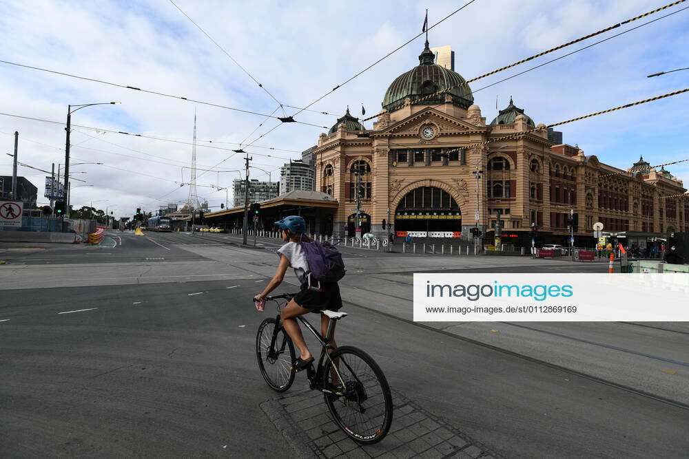 VICTORIA CORONAVIRUS COVID19, A cyclist rides down Swanston Street in Melbourne, Saturday, February 13, 2021. Victoria has entered a short, sharp circuit-breaker lockdown for five days amid fears the highly infectious UK strain of coronavirus has spread in the community. ( NO ARCHIVING, , NO USE IN BOOKS WITHOUT CONSENT MELBOURNE VIC AUSTRALIA