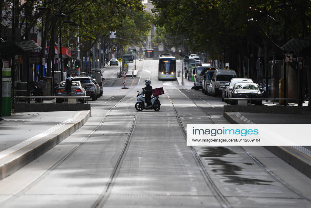 VICTORIA CORONAVIRUS COVID19, A delivery driver is seen on Bourke Street in Melbourne, Saturday, February 13, 2021. Victoria has entered a short, sharp circuit-breaker lockdown for five days amid fears the highly infectious UK strain of coronavirus has spread in the community. ( NO ARCHIVING, , NO USE IN BOOKS WITHOUT CONSENT MELBOURNE VIC AUSTRALIA