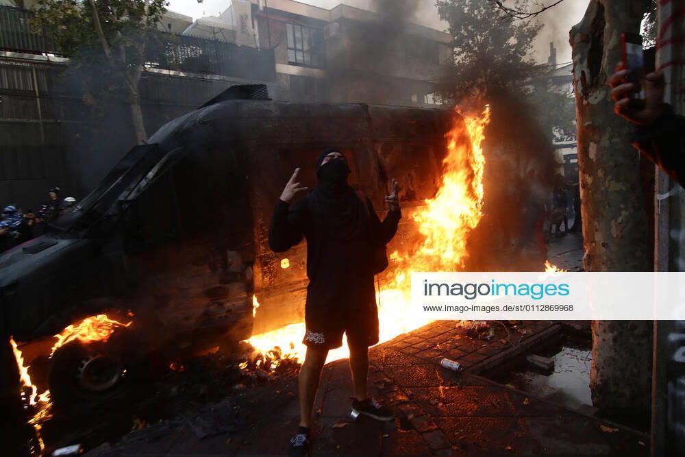 Carabineros van is set on fire during the protest by prisoners of the social outbreak in the center of the capital during the coronavirus pandemic Javier Salvo Aton Chile, Santiago Chile Aton 488482