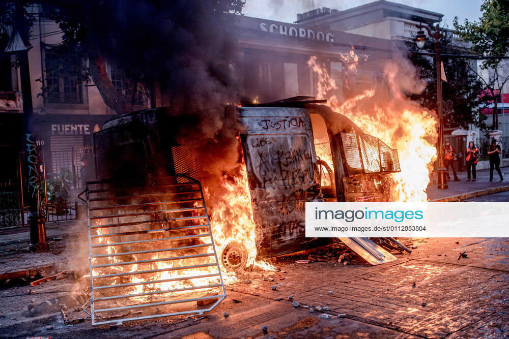 Chilean police vehicle seen set ablaze by protesters during protests against police brutality in Santiago..Several protesters took to the streets in a protest that saw a police vehicle being burnt down following the death of a street artist who was shot by police in the city of Panguipulli after he refused to co-operate with a police search. Santiago Chile - ZUMAs197 20210212_zaa_s197_240
