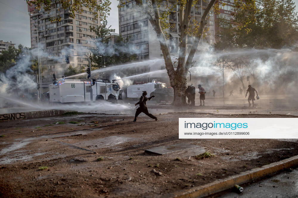 A protester confront the police during protests against police brutality in Santiago..Several protesters took to the streets in a protest against President Sebastian Pinera s government, attacking and burning a police vehicle hence injuring an officer following the death of a street artist who was shot by police in the city of Panguipulli after he refused to co-operate with a police search. Santiago Chile - ZUMAs197 20210212_zaa_s197_264