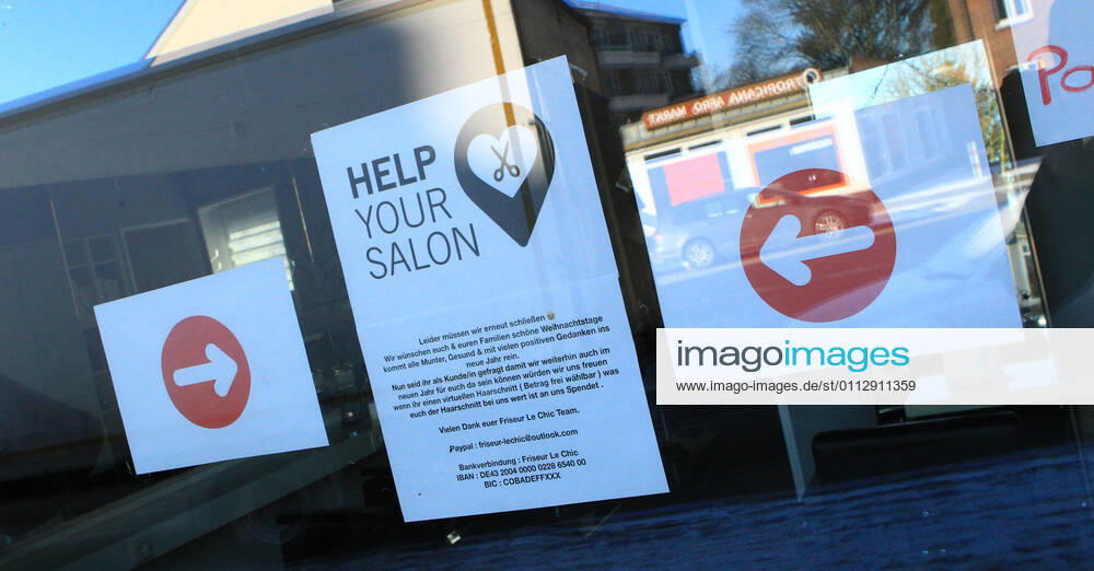 In the window of a hairdressing salon closed because of the lockdown hangs a note in which the shop owners ask for donations Barmbek Hamburg