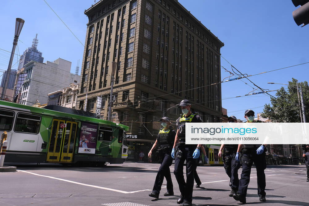 VICTORIA CORONAVIRUS COVID19, Victorian Police officers walk around Melbourne?s CBD , Monday, February 15, 2021. Victorians are in lockdown for the third time amid fears the highly infectious UK strain of coronavirus has spread in the community. ( NO ARCHIVING, , NO USE IN BOOKS WITHOUT CONSENT MELBOURNE VIC AUSTRALIA