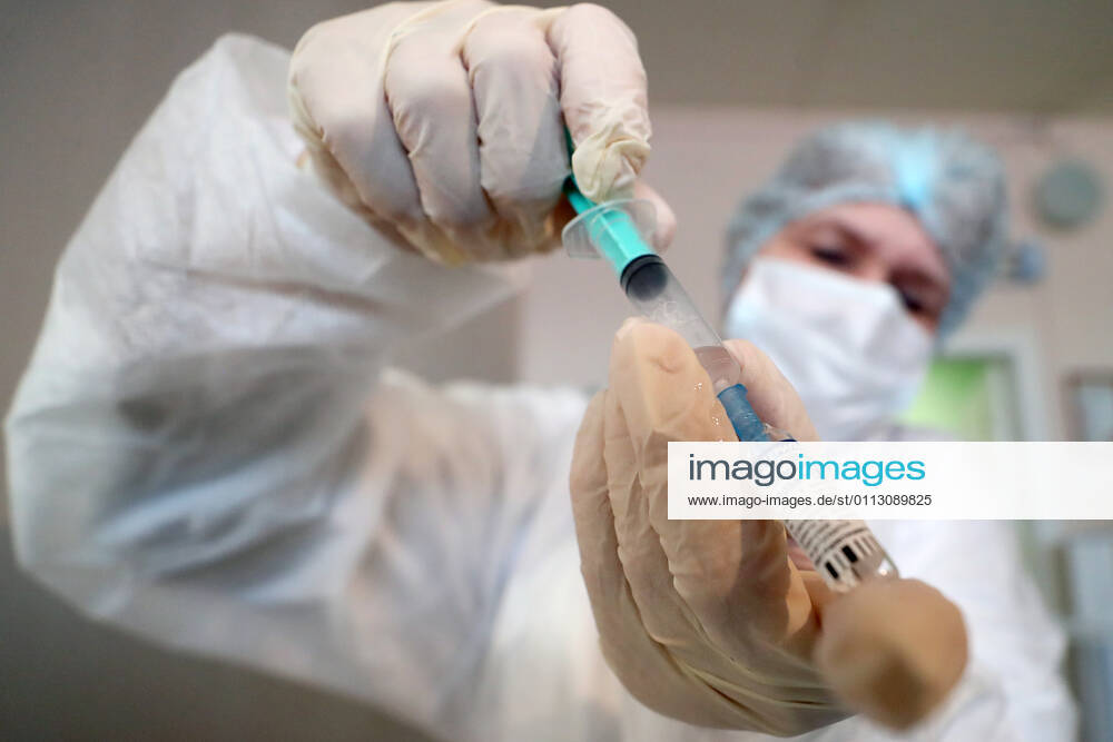 ST PETERSBURG, RUSSIA — FEBRUARY 15, 2021: A medical worker fills a syringe with the Gam-COVID-Vac vaccine (under the brand name of Sputnik V) while vaccinating people against COVID-19 at No 7 Neuropsychiatric Care Home. Alexander Demianchuk TASS TS0F6D1A