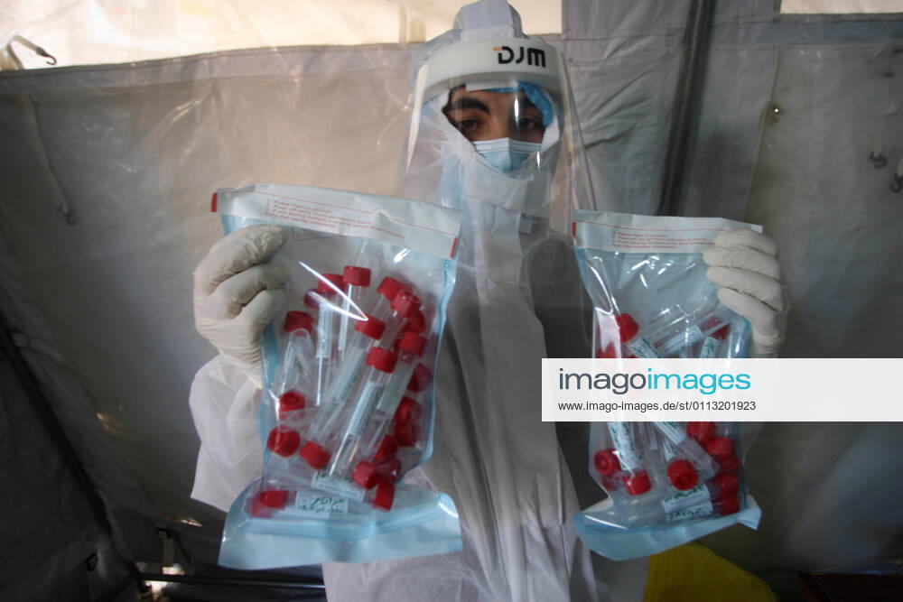 A Palestinian paramedic wearing a full protective suit, organizes COVID-19 tests on Tuesday, in Khan Yunis, southern of Gaza, February 16, 2021. The Palestinian Authority claims that Israel is stopping delivery of COVID-19 vaccines into Gaza, from the West Bank. GAZ2021021618 IsmaelxMohamad