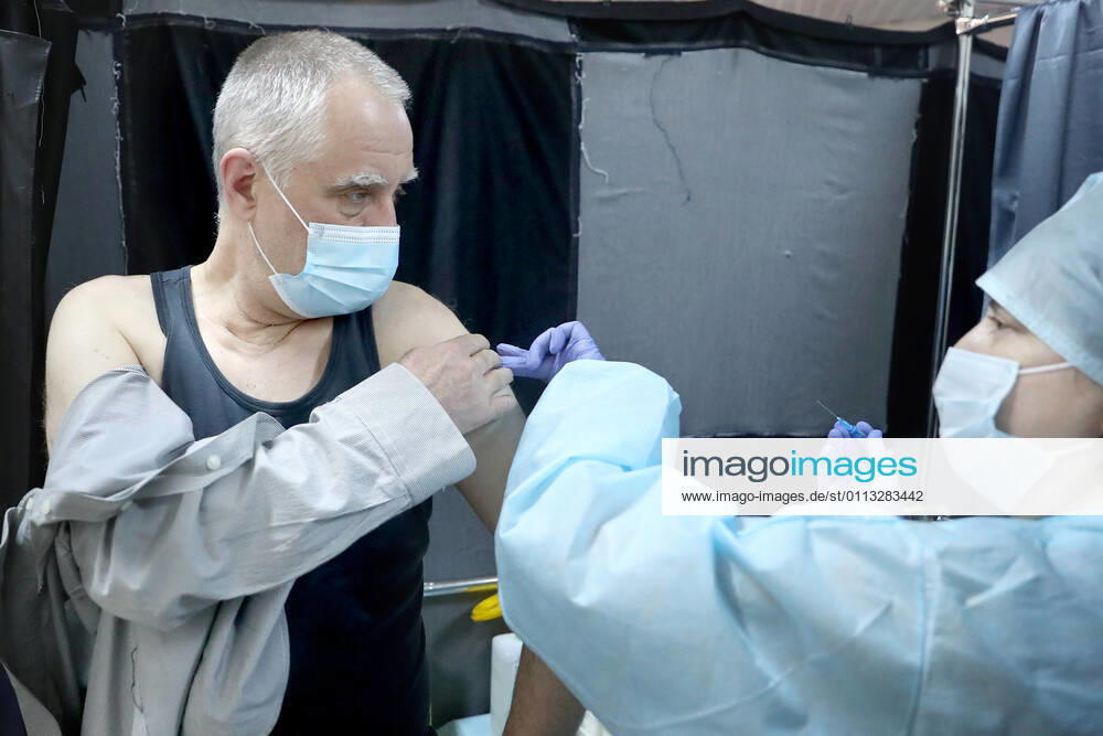 A man receives an injection of the Gam-COVID-Vac (Sputnik-V) vaccine against COVID-19 in a mobile vaccination unit set up at the Dirizhabl Airship shopping centre, vaccination free of charge, no prior appointment required. Donat Sorokin TASS TS0F7013