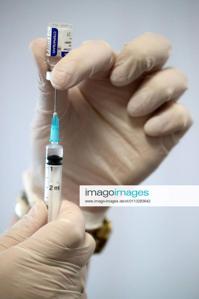 MOSCOW, RUSSIA – FEBRUARY 17, 2021: A nurse fills a syringe with the Gam-COVID-Vac vaccine (under the brand name of Sputnik V) at a new temporary COVID-19 vaccination site in the VDNKh Exhibition Centre. A mobile vaccination team is providing vaccines free of charge and without prior sign-up. Since the start of the pandemic, Moscow has confirmed more than 960,600 cases of COVID-19. Since late January, the number of new confirmed cases has been increasing in the Russian capital by more than 1,200 daily. Sergei Savostyanov TASS TS0F700E