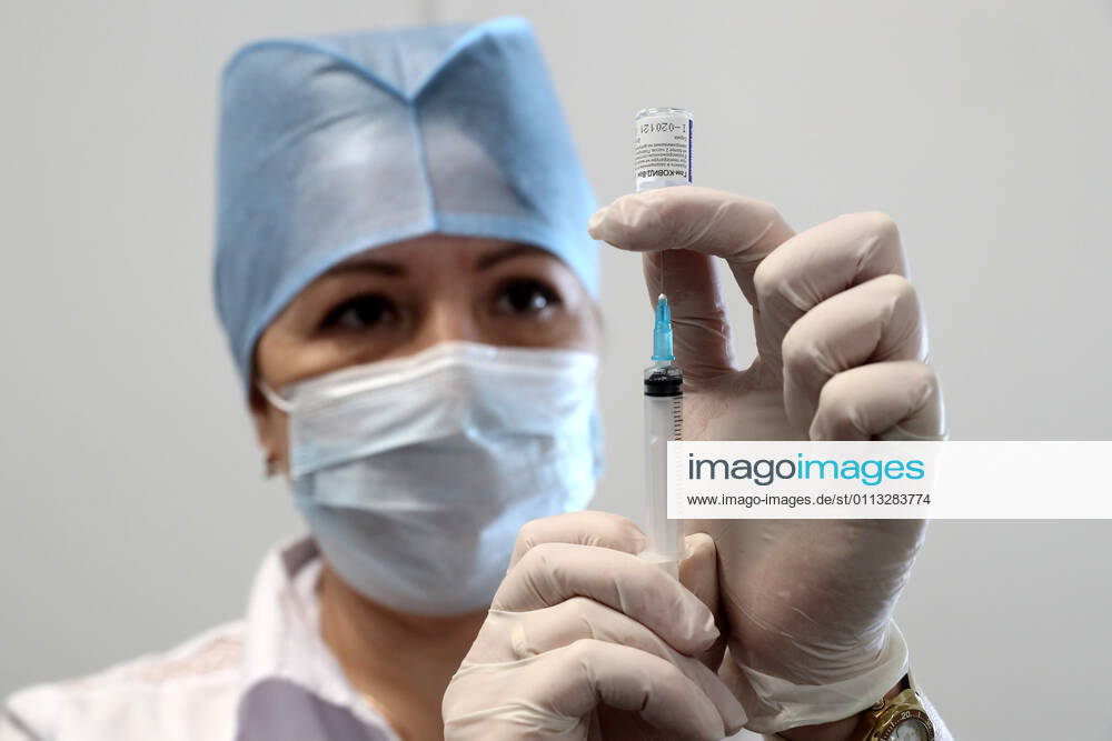 MOSCOW, RUSSIA â€“ FEBRUARY 17, 2021: A nurse fills a syringe with the Gam-COVID-Vac vaccine (under the brand name of Sputnik V) at a new temporary COVID-19 vaccination site in the VDNKh Exhibition Centre. A mobile vaccination team is providing vaccines free of charge and without prior sign-up. Since the start of the pandemic, Moscow has confirmed more than 960,600 cases of COVID-19. Since late January, the number of new confirmed cases has been increasing in the Russian capital by more than 1,200 daily. Sergei Savostyanov TASS TS0F7011