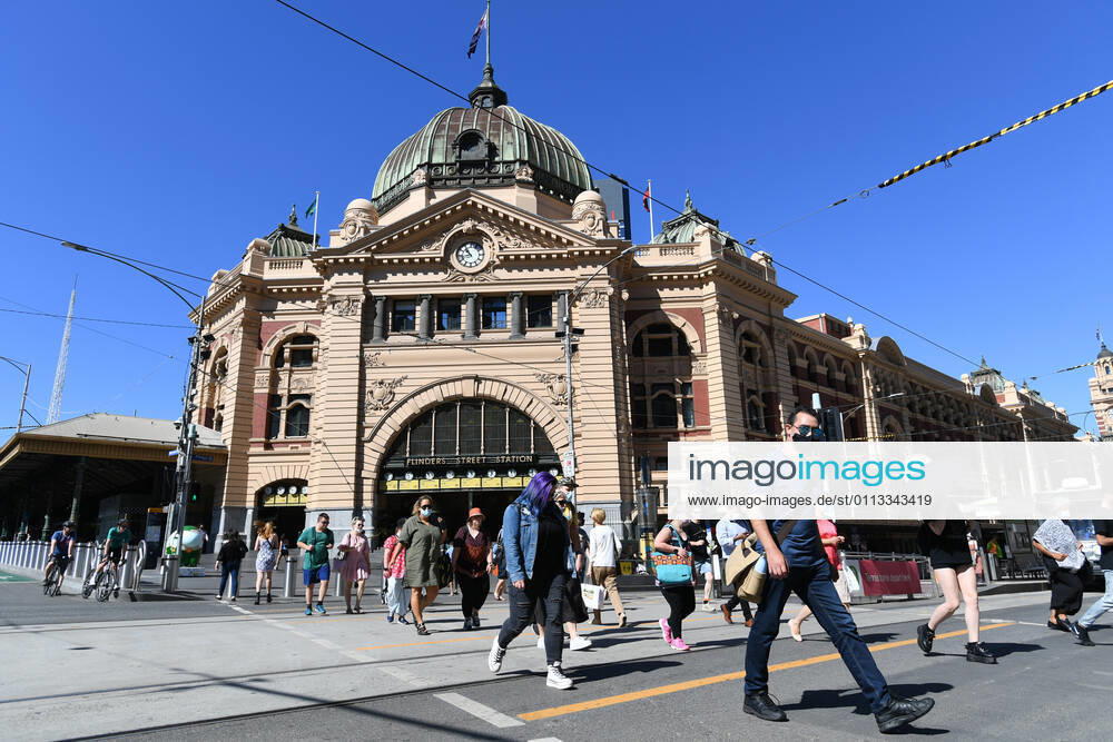 VICTORIA CORONAVIRUS COVID19, People cross at the intersection in front of Flinders Street station in Melbourne, Thursday, February 18, 2021. Victoria has recorded no new locally acquired coronavirus cases as life returns to COVID-normal after the state s five-day circuit breaker lockdown. ( NO ARCHIVING, , NO USE IN BOOKS WITHOUT CONSENT MELBOURNE VIC AUSTRALIA