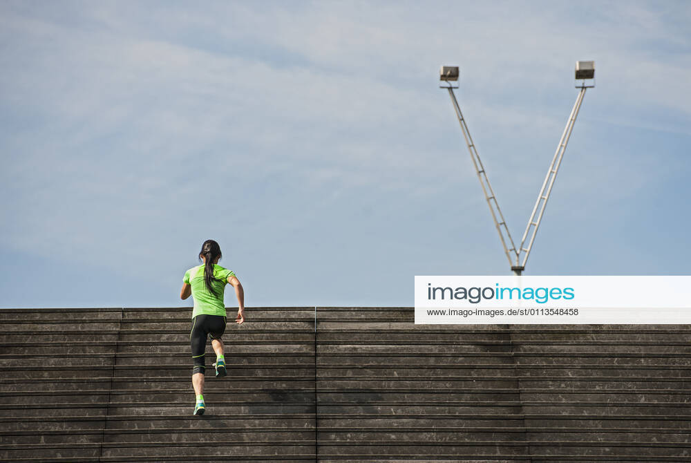 Woman running up wooden stairs in Paris France, Île-de-France, Paris CR_THHE210219-656435-01 ,model released, Symbolfoto