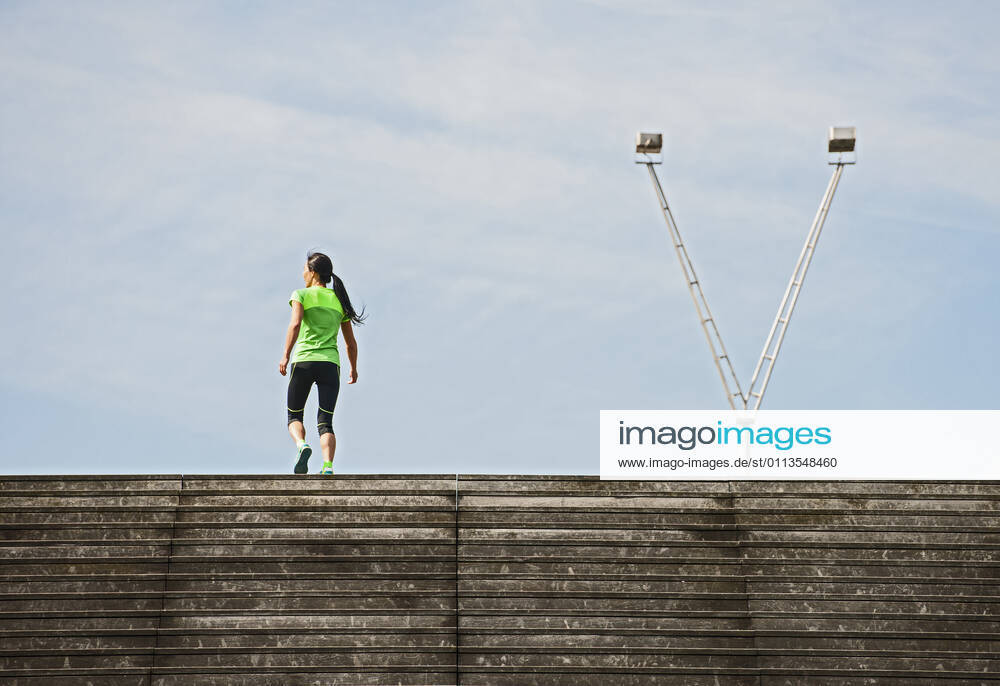 Woman running up wooden stairs in Paris France, Île-de-France, Paris CR_THHE210219-656436-01 ,model released, Symbolfoto
