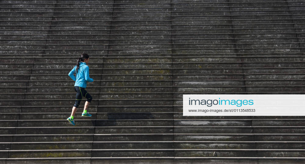 Woman running up wooden stairs in Paris France, Île-de-France, Paris CR_THHE210219-656446-01 ,model released, Symbolfoto