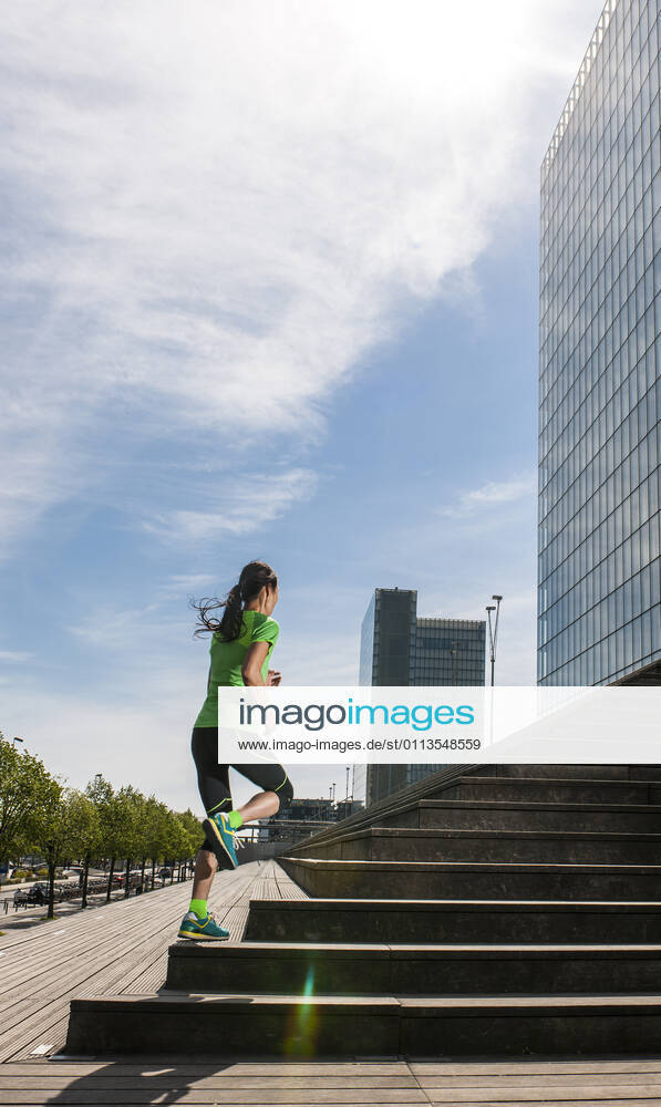 Woman running up wooden stairs in Paris France, Île-de-France, Paris CR_THHE210219-656449-01 ,model released, Symbolfoto