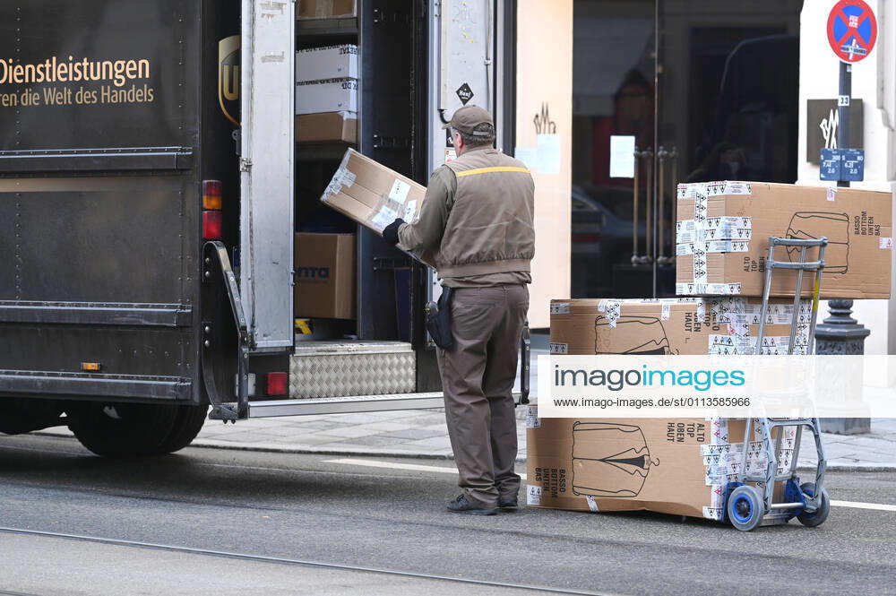 UPS parcel driver at work,parcel carrier,United Parcel in downtown in munich service,parcel,parcel service,deliver,deliver,unload,ship,transporter,hand truck