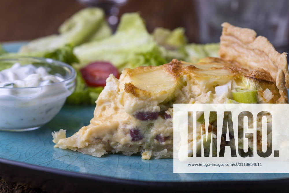 French Quiche Lorraine with salad on wood 1035308197