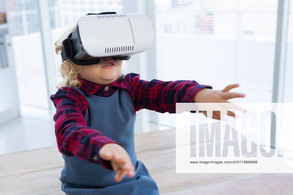 Businesswoman looking through virtual reality simulator while sitting on table Businesswoman looking through virtual reality simulator while sitting on table in office, model released, Cape Town, South Africa, 2017-04-12T23:00:00.000Z, 1050488.jpg, business person, virtual reality simulator, sitting, table, office, childhood, innocence, cute, smart casual, workplace, business, profession, occupation, confidence, designer, creative, fashion, design professional, wooden, wood, technology, wireless, wearable computer, computer, exploration, futuristic, discovery, innovation, wireless technology, virtual reality, gesturing, arms raised, businesswoman, well dressed, smart, elegant, classy, stylish, imagination, aspirations, adult imitation, i