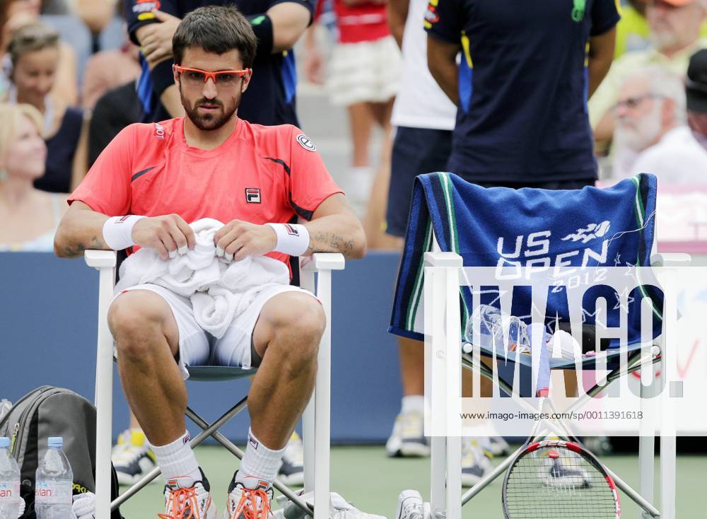 Janko Tipsarevic of Serbia sits during a change over in his match on day 11 in Arthur Ashe Stadium at the BillieJeanKing National Tennis Center in New York City on September 6, 2012. Ferrer defeated Tipsarevic in 5 sets. NYP20120906128