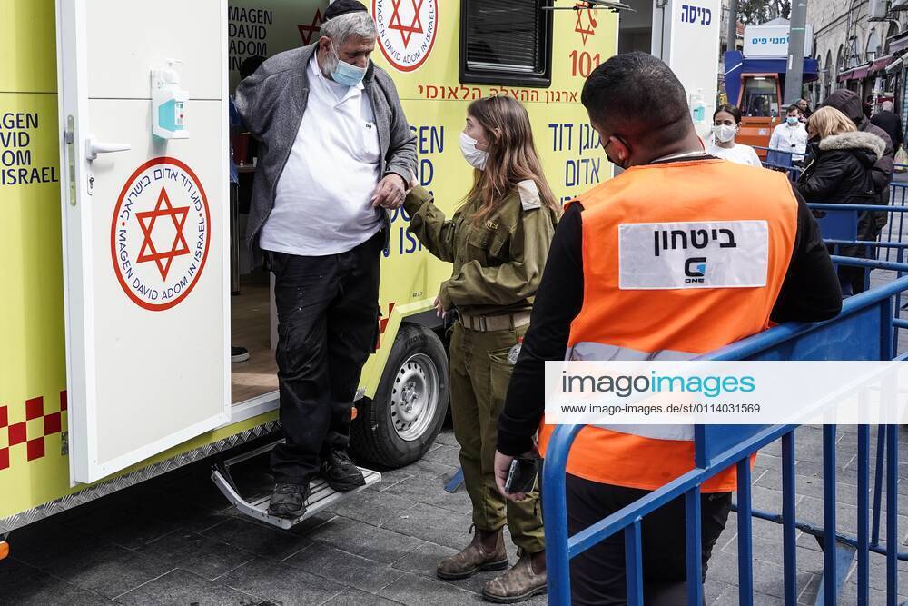 The IDF Home Front Command in coordination with Magen David Adom, serving as the Israeli Red Cross organization and leading EMS, make COVID-19 vaccinating more accessible to those still in denial or refusal operating a mobile vaccination station out of a caravan at Jerusalemâ€⠢s Shuk Mahane Yehuda Market. Jerusalem Israel - ZUMAa126 20210224_zap_a126_015