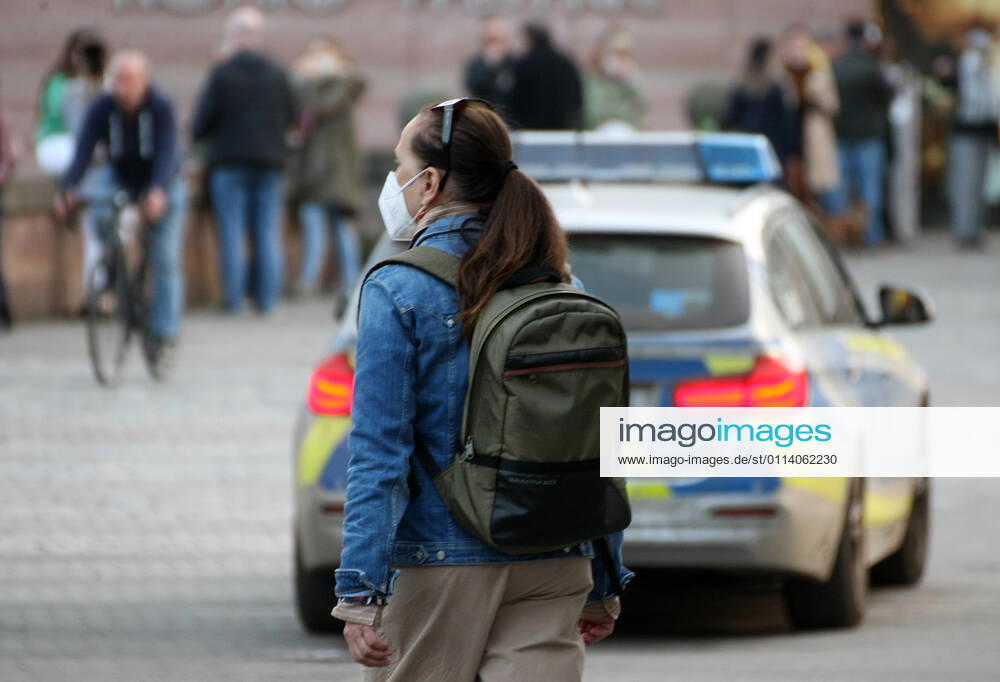 A girl with Safety Mask is seen as the Police make a Kontrolle during the Hard Lockdown of the Covid 19 Coronavirus Pandemie in Nurnberg , Bayern , Deutschland . February 24, 2021.