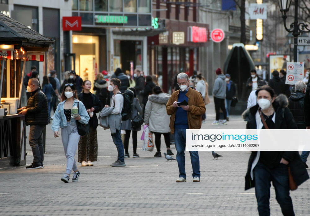 People walk in the street with Safety Mask during the Hard Lockdown of the Covid 19 Coronavirus Pandemie in Nurnberg , Bayern , Deutschland . February 24, 2021.