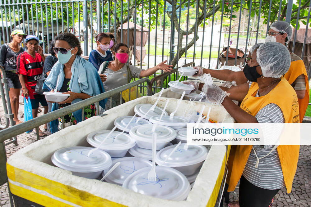 COVID-19 Food Assistance in Brazil RIO DE JANEIRO, BRAZIL, FEB 25: COVID-19 FOOD ASSISTANCE - NGO volunteers distribute free meal to people in precarious situations during the COVID-19 pandemic at downtown Rio , on Feb. 25, 2021. Rio de Janeiro Brazil 6209_232872