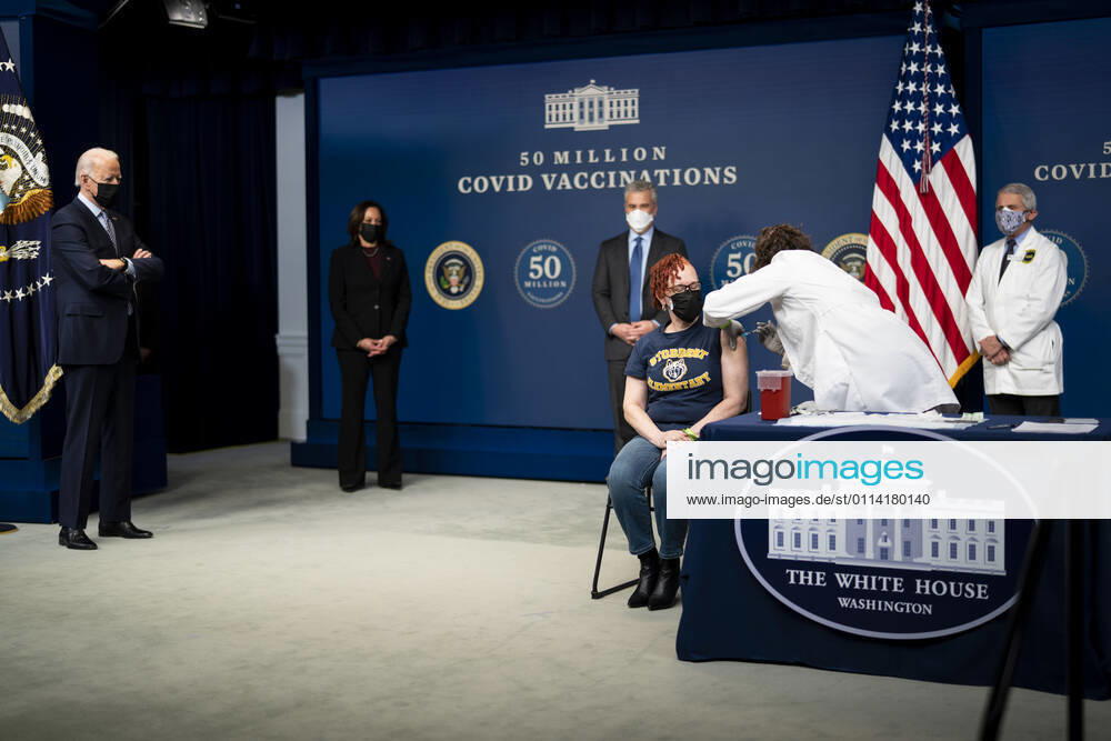 President Joe Biden looks on as a nurse gives a vaccine to Victoria Legerwood Rivera, an Attendance Counselor at Stoddert Elementary School in Northwest DC, as he participates in an event commemorating the 50 million COVID-19 vaccine shot during a ceremony at the White House, Thursday, Feb. 25, 2021 Washington USA - ZUMAs152 20210225_zaa_s152_201