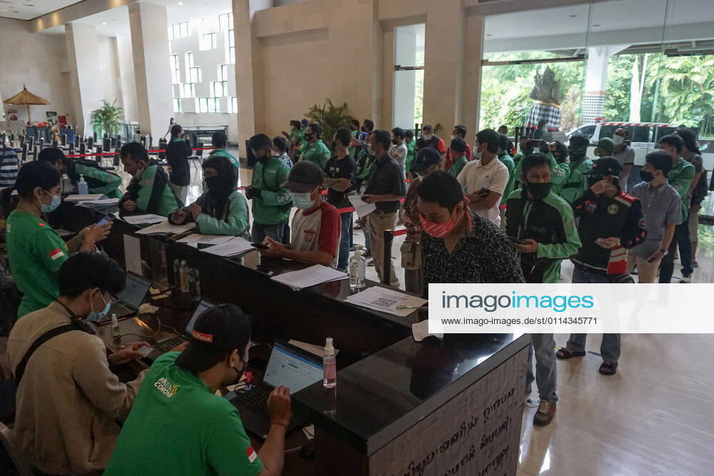 Hundreds of online taxi drivers and touirsm workers lined up to get their vaccination turn. Bali to held the second stage of Covid-19 mass vaccination towards tourism workers and online-taxi drivers at Bali Nusa Dua Convention Center (BNDCC), in order to accelerate tourism industry recovery. About 5000 doses of vaccines are targeted to be completed within 1 week. Badung Indonesia - ZUMAb245 20210228_zip_b245_005