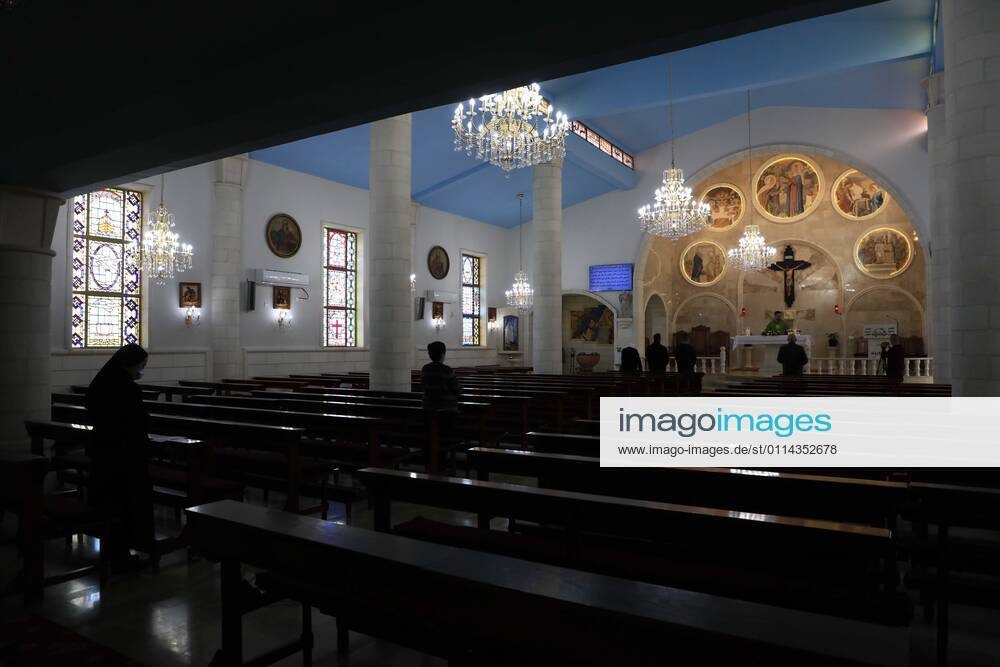 Jenin, West Bank, Palestinian Territory: Christian worshippers pray inside Church, amid the coronavirus lockdown in the town of Zababdeh, south of Jenin, in the West Bank on February 28, 2021. Prime Minister Mohammad Shtayyeh announced a new set of restrictions in response to a recent surge in coronavirus infections, including of British and South African mutants, in Palestine.A lockdown of all public and private schools for all classes, except for high school students for a period of 12 days, including kindergartens..A lockdown of all universities, educational and vocational institutes and shifting to distance e-learning programs. A maximum of 50 percent of administrative staff are allowed access to universities..Movemen - ZUMAap3_ 20210228_zaf_ap3_036