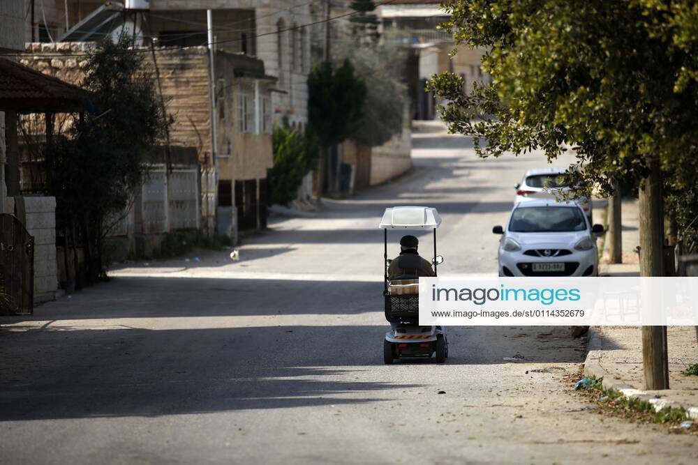 Jenin, West Bank, Palestinian Territory: A man walks on an empty street, amid the coronavirus lockdown in the town of Zababdeh, south of Jenin, in the West Bank on February 28, 2021. Prime Minister Mohammad Shtayyeh announced a new set of restrictions in response to a recent surge in coronavirus infections, including of British and South African mutants, in Palestine.A lockdown of all public and private schools for all classes, except for high school students for a period of 12 days, including kindergartens..A lockdown of all universities, educational and vocational institutes and shifting to distance e-learning programs. A maximum of 50 percent of administrative staff are allowed access to universities..Movement between - ZUMAap3_ 20210228_zaf_ap3_037