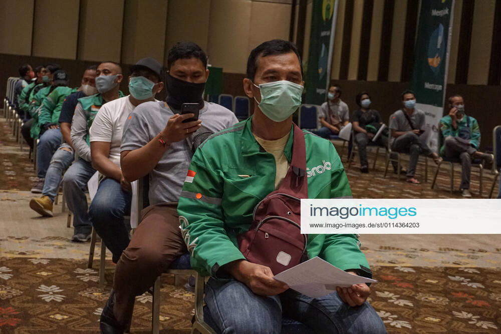 Hundreds of online taxi drivers and touirsm workers lined up to get their vaccination turn. Bali to held the second stage of Covid-19 mass vaccination towards tourism workers and online-taxi drivers at Bali Nusa Dua Convention Center (BNDCC), in order to accelerate tourism industry recovery. About 5000 doses of vaccines are targeted to be completed within 1 week. Badung Indonesia - ZUMAb245 20210228_zip_b245_016