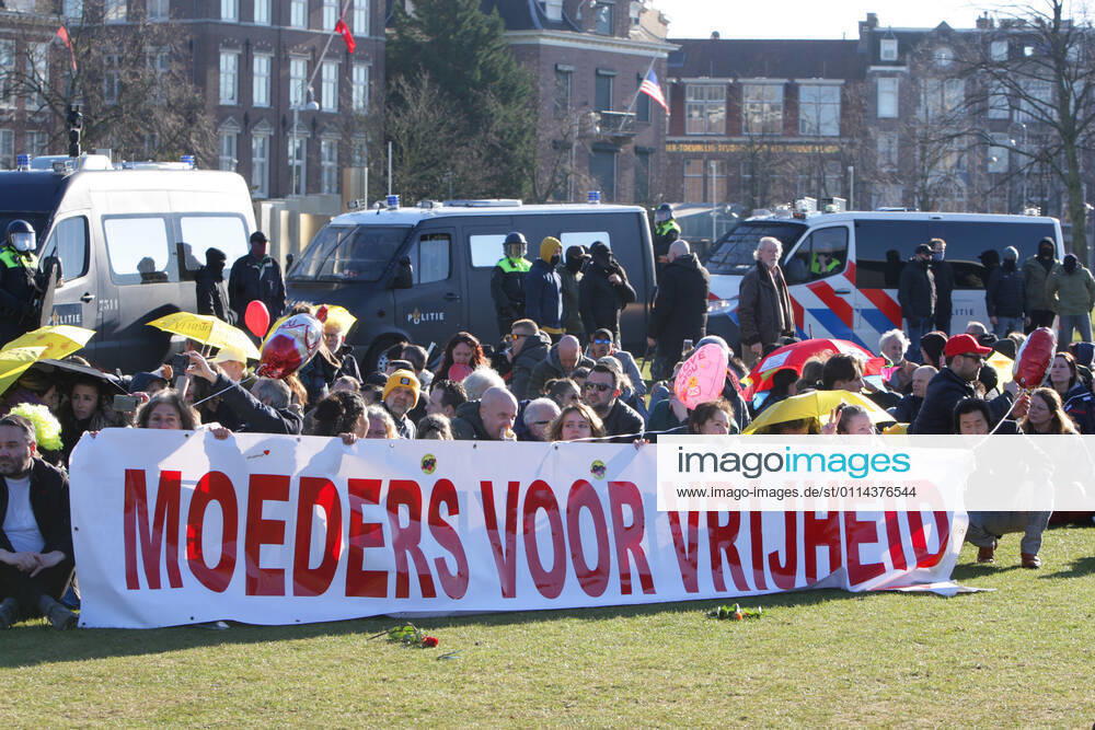 Anti-Lockdown supporters hold a banner Mother For Freedom during illegal demonstration against the coronavirus measures at the Museumplein on February 28, 2021 in Amsterdam,Netherlands. Amsterdam Mayor Femke Halsema classified the Museumplein as security risk area , giving police officers the right to check and search anybody in that area to prevent illegal demonstration and vandalism. Amsterdam Netherlands