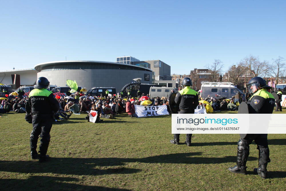 Dutch anti-riot police enclose anti-lockdown supporters during illegal demonstration against the coronavirus measures at the Museumplein on February 28, 2021 in Amsterdam,Netherlands. Amsterdam Mayor Femke Halsema classified the Museumplein as security risk area , giving police officers the right to check and search anybody in that area to prevent illegal demonstration and vandalism. Amsterdam Netherlands