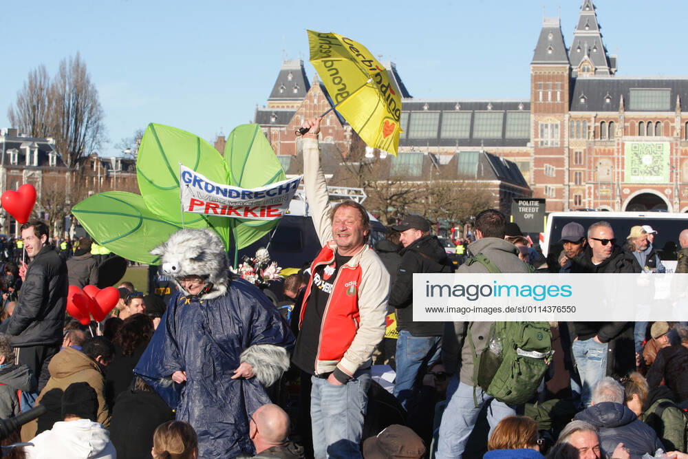 Anti-lockdown supporters take during illegal demonstration against the coronavirus measures at the Museumplein on February 28, 2021 in Amsterdam,Netherlands. Amsterdam Mayor Femke Halsema classified the Museumplein as security risk area , giving police officers the right to check and search anybody in that area to prevent illegal demonstration and vandalism. Amsterdam Netherlands