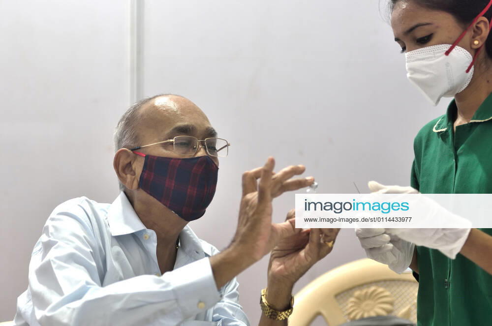 A senior citizen inspects a Covishield vial while getting their first dose of a Covid-19 vaccination, at BKC on March 1, 2021 in Mumbai, India. India?s Covid-19 vaccination drive was extended today to include the elderly and those with co-morbidities. (Photo by Satish Bate Hindustan Times) Covid Vaccination Phase 2 Starts In India