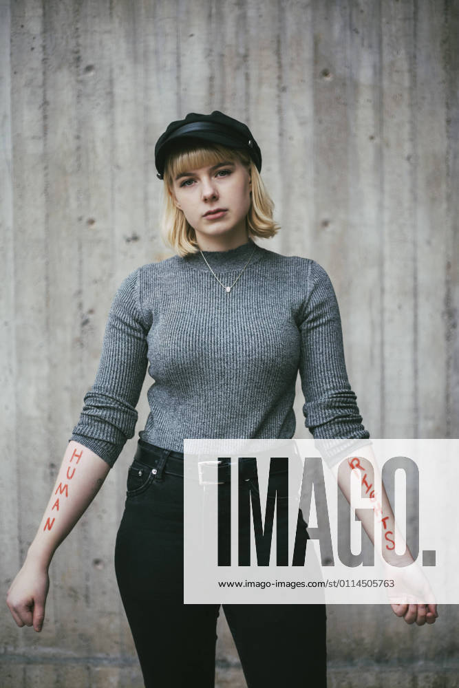 Portrait of female protestor showing equal rights written on hand against wall Sweden, Stockholm, model released