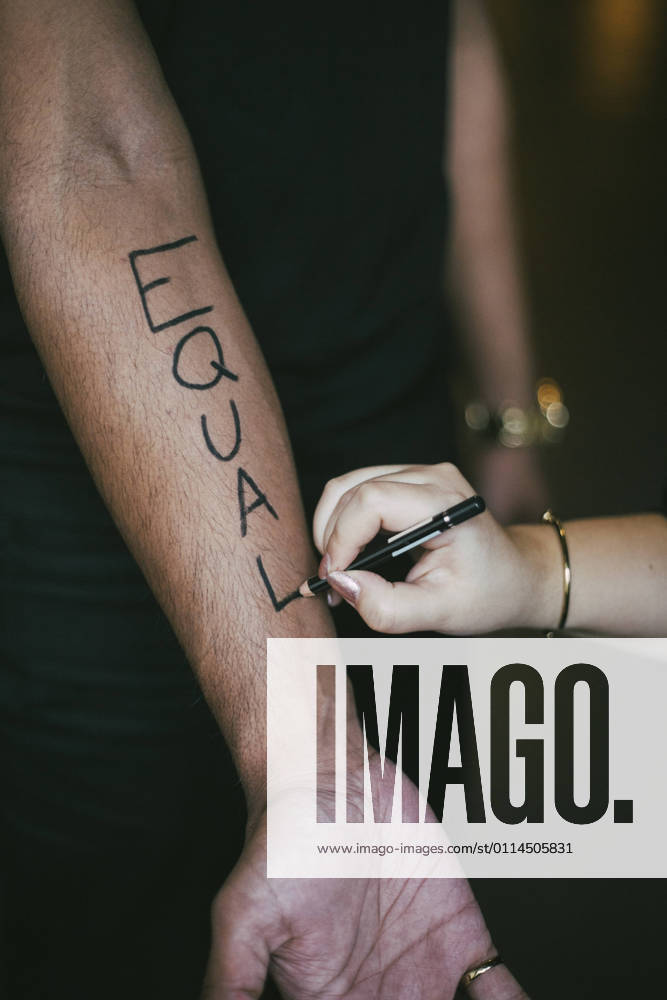 Female activist writing on man s hand for social issues Sweden, Stockholm, model released