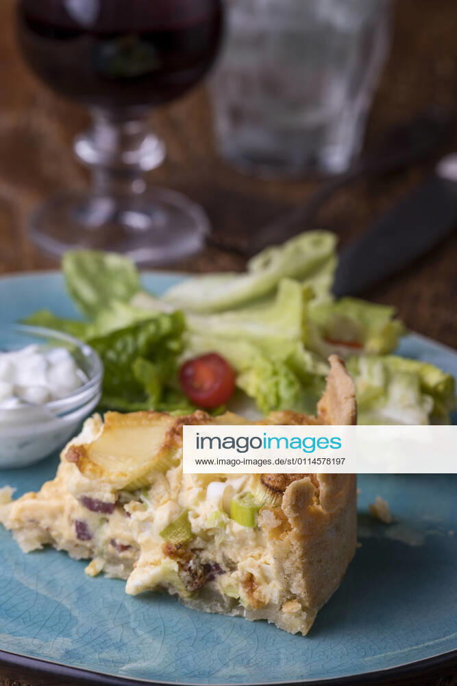 French Quiche Lorraine with salad on wood 1035308209