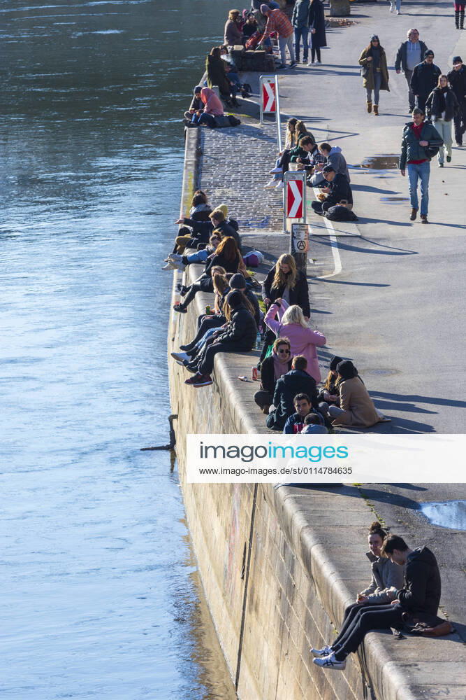 People sit in the sun at canal Donaukanal Wien, Vienna Wien Austria 02. Leopoldstadt