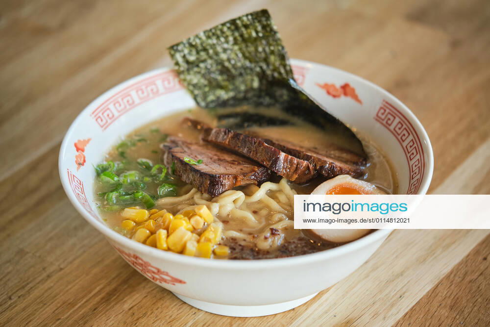 Stock photo of yummy ramen soup with boiled egg and meat in japanese restaurant., Model released