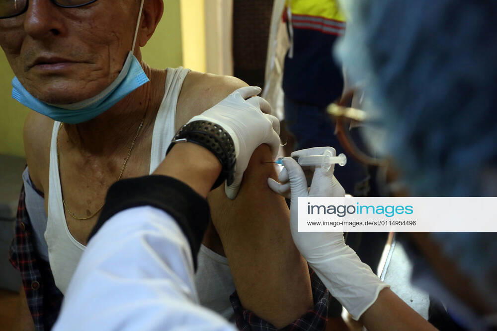 An elderly man receives a dose of Covishield COVID-19 vaccine at a hospital in Kathmandu,Nepal on March 8, 2021. Nepal started the nationwide campaign to inoculate the elderly population,over 65 years with with Covishield,the Oxford-AstraZeneca vaccine. Kathmandu Nepal - ZUMAs233 20210308_zap_s233_001
