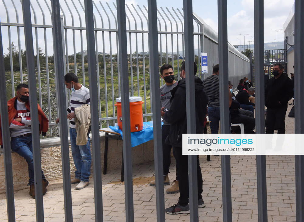 Palestinian workers wait fifteen minutes after receiving the first dose of the Moderns COVID-19 vaccine at the Lamed Hei Checkpoint between Gush Etzion and Beit Shemesh, on Monday, March 8, 2021. Israel started a two week campaign to vaccine some 100,000 Palestinian workers from the West Bank who hold permits to work in Israel and Jewish settlements. The vaccination campaign is a joint project by the Israeli Heath Ministry, Ministry of Defense, Land Crossing Authority and the Coordination of Government Activities in the Territories. JER2021030813 DEBBIExHILL