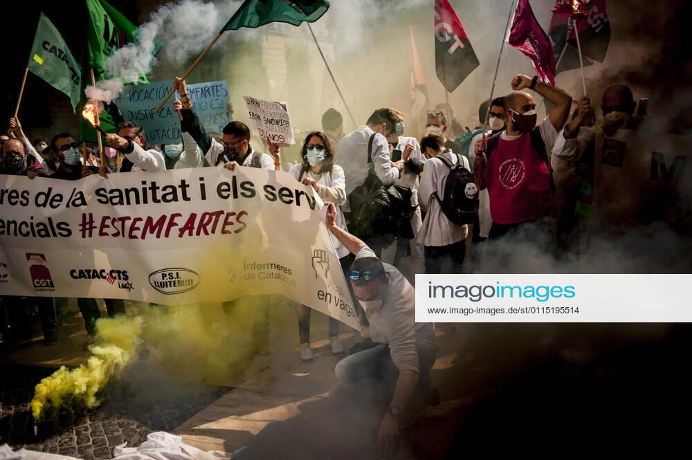Healthcare workers protest amid smoke as they gather in Barcelona to demand an improvement in their working conditions aggravated by the coronavirus pandemic. Barcelona Spain - ZUMAb137 20210310_zap_b137_004