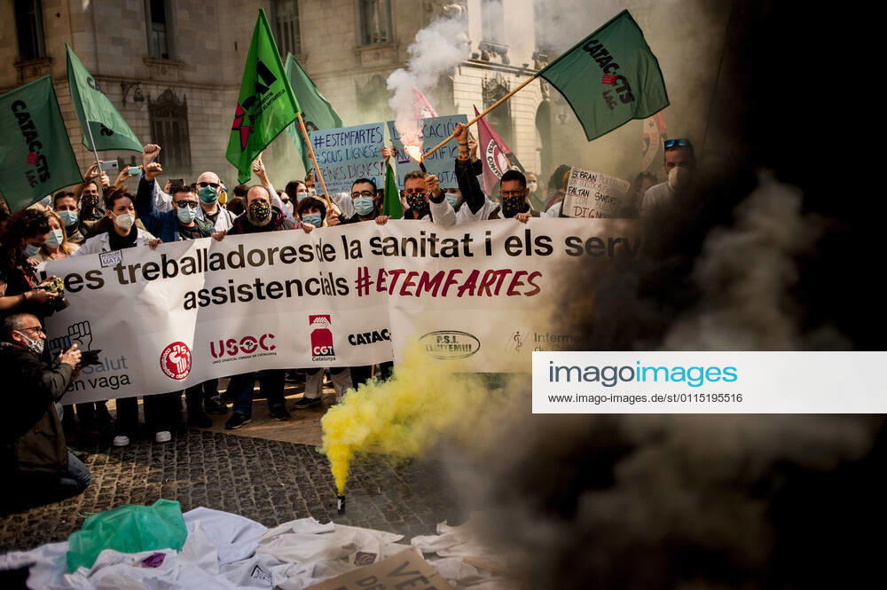 Healthcare workers protest amid smoke as they gather in Barcelona to demand an improvement in their working conditions aggravated by the coronavirus pandemic. Barcelona Spain - ZUMAb137 20210310_zap_b137_005
